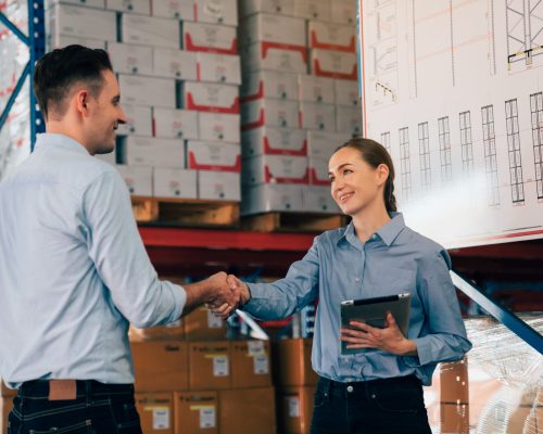 Warehouse manager talking and pointing towards shelf while checking product in warehouse, Logistic industry concept.